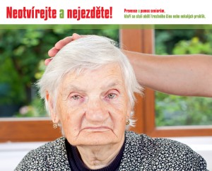 Unhappy elderly woman sitting at the table